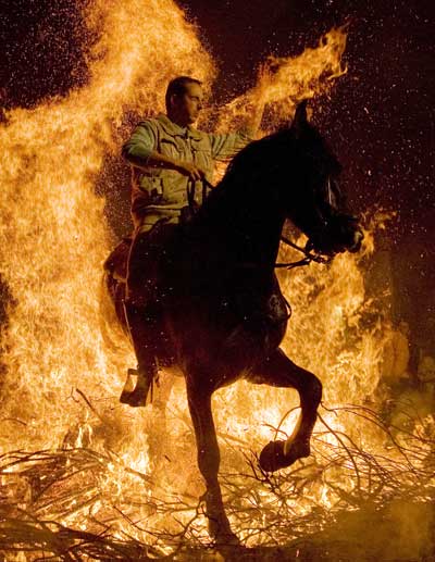 Традиции. В центральной части Испании всадники перепрыгивают через костер в день святого заступника животных. Фото: JAVIER SORIANO /AFP/Getty Images