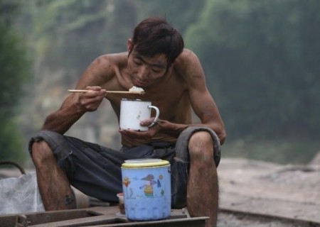 QIANWEI COUNTY, CHINA - OCTOBER 5: (CHINA OUT) A worker dines at the Dingxing Colliery on October 5, 2007 in Qianwei County of Leshen City, Sichuan Province, China. According to state media, In 2006, China produced 35 per cent of the world's coal  and 5,000 lives were claimed in coal mining accidents. (Photo by China Photos/Getty Images)