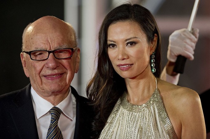 (FILES) This file photo taken on June 11, 2011 shows media executive Rupert Murdoch (L) and his wife Wendi Deng arriving on the red carpet during the opening ceremony of the Shanghai International Film Festival (SIFF) in Shanghai. Wendi Deng, who has emerged as an unlikely heroine after leaping to defend her 80-year-old husband Rupert Murdoch from a pie-wielding protester on July 19, 2011, has a reputation for formidable ambition and fierce loyalty. AFP PHOTO / FILES / Philippe Lopez (Photo credit should read PHILIPPE LOPEZ/AFP/Getty Images)