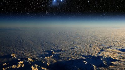 Вид на Землю из космоса и звёздное скопление Плеяды.  Фото: Shutterstock*