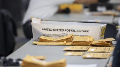 Бюллетени для заочного голосования лежат на столе в ожидании обработки в Кобо-центре, Детройт, штат Мичиган, 4 ноября 2020 года. Elaine Cromie/Getty Images