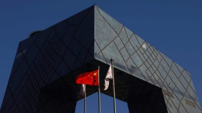 FILE PHOTO: A Chinese flag flutters outside the CCTV headquarters, the home of Chinese state media outlet CCTV and its English-language sister channel CGTN, in Beijing, China February 5, 2021. REUTERS/Carlos Garcia Rawlins