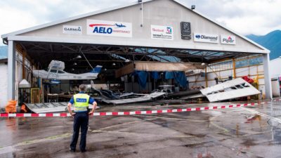 Ангар и несколько припаркованных небольших самолетов в местном аэропорту Локарно в Магадино на юге Швейцарии, были сильно повреждены после грозы 13 июля 2021 г. (Ti-Press / Elia Bianchi / Keystone через AP)