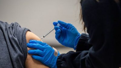Человеку делают прививку в Челси, штат Массачусетс, 16 февраля 2021 г. (Джозеф Прециозо / AFP через Getty Images)