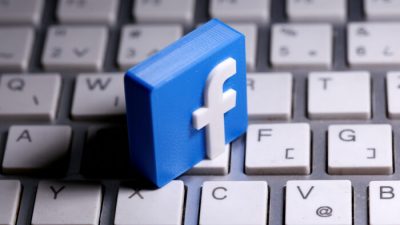 Напечатанный на 3D-принтере логотип Facebook лежит на клавиатуре 25 марта 2020 г. Dado Ruvic / Reuters