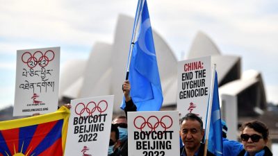 Протестующие держат плакаты и транспаранты во время демонстрации с призывом к правительству Австралии бойкотировать зимние Олимпийские игры 2022 года в Пекине из-за нарушений прав человека в Китае, Сидней, Австралия, 23 июня 2021 года.  Saeed Khan/AFP via Getty Images