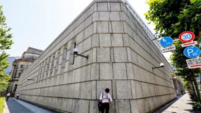 Мужчина смотрит на мобильный телефон перед зданием Банка Японии в Токио, Япония, 16 июня 2017 г. Toru Hanai / Reuters