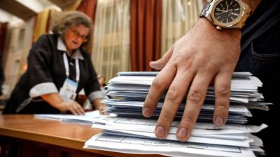 Члены местной избирательной комиссии подсчитывают бюллетени на избирательном участке после последнего дня трехдневных парламентских выборов в Москве. Фото: ALEXANDER NEMENOV/AFP via Getty Images