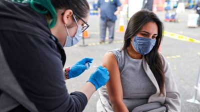Женщина получает вакцину от COVID-19 в Лос-Анджелесе, Калифорния, 25 марта 2021 года. (Lucy Nicholson/Reuters)