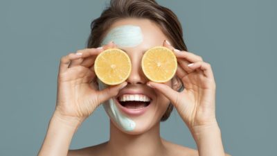 Portrait of beautiful woman with blue cream mask on her face.